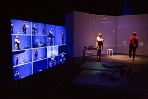 a video monitor shows multiple camera angles as the play I Am The Cheese is filmed