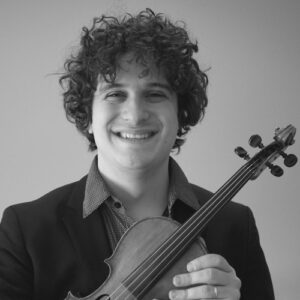 Photo of Drew Jurecka holding a violin